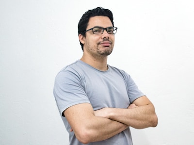 confident man wearing glasses in gray tshirt