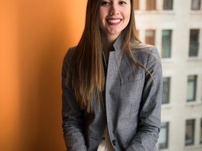 professional woman smiling in business attire office setting